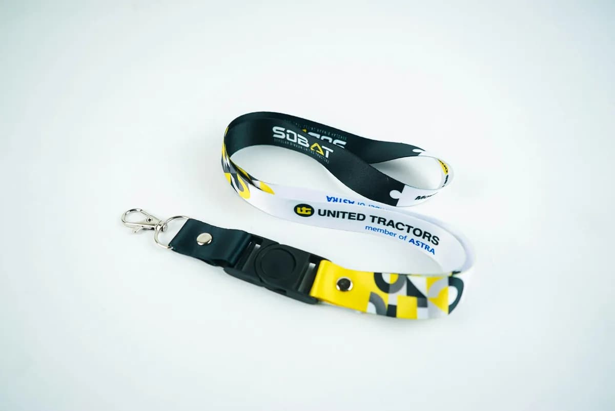A printed lanyard with a badge holder on a white background