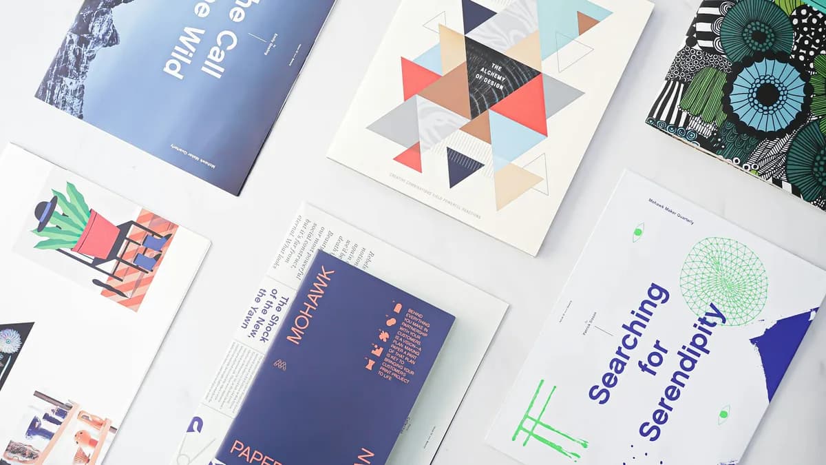Printed brochures, booklets and cards laid out on a table
