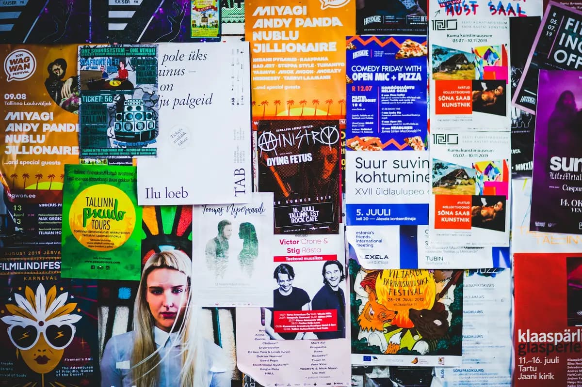 A wall covered with printed event posters