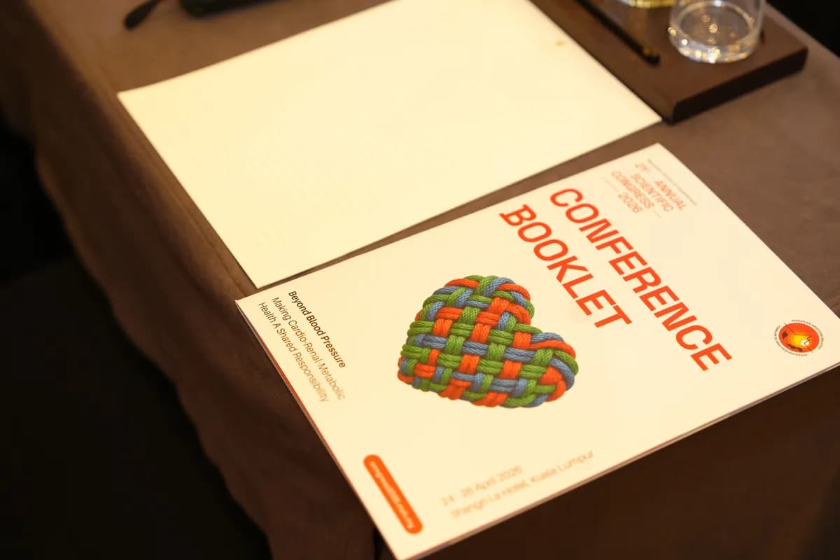 Printed booklet and paper collateral on a table